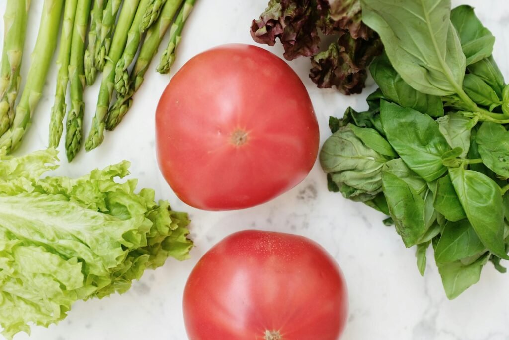 Colorful fresh vegetables and fruits arranged on wooden surface for natural gut health