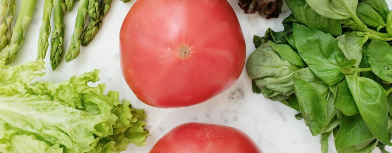 Colorful fresh vegetables and fruits arranged on wooden surface for natural gut health