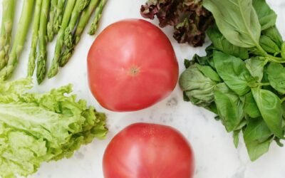 Colorful fresh vegetables and fruits arranged on wooden surface for natural gut health