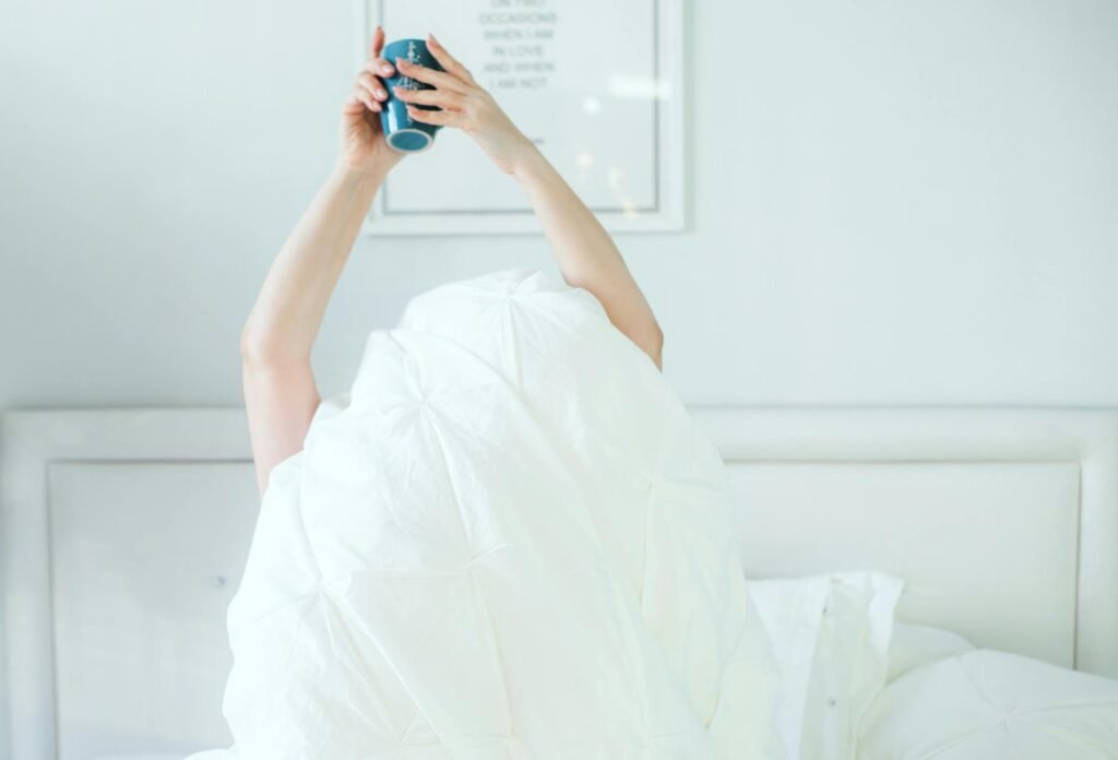 Woman stretching in sunlight during morning wellness routine at home
